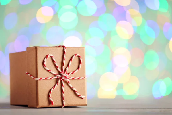 Gift box with rope on lights background