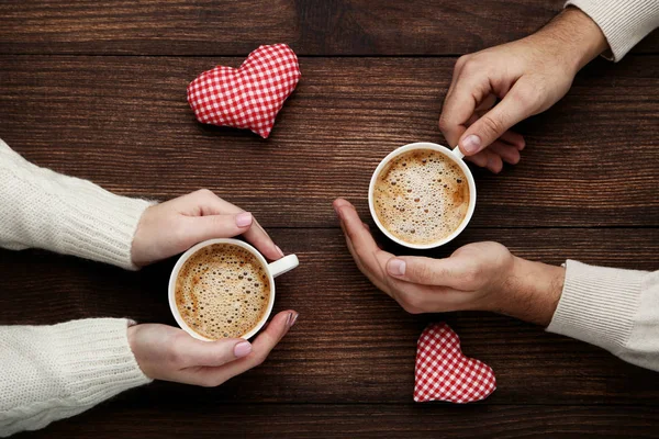 Female Male Hands Holding Cups Coffee Red Fabric Hearts Wooden — Stock Photo, Image