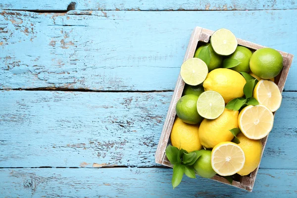 Citróny Citrusy Zelenými Listy Bedně Modré Dřevěný Stůl — Stock fotografie