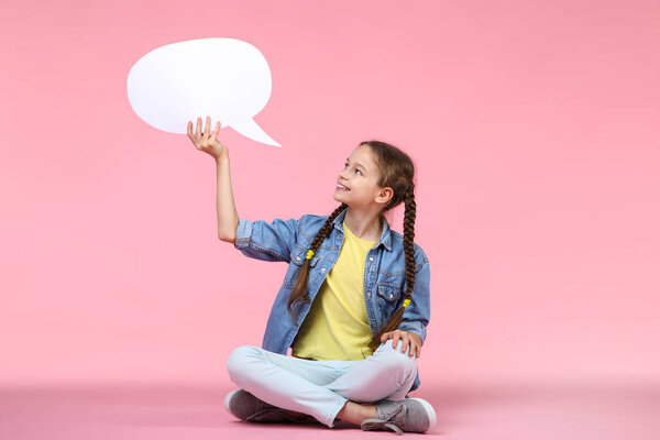 Young girl with speech bubble on pink background