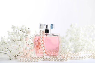 Beyaz arka plan üzerinde eustoma çiçekli parfüm şişesi