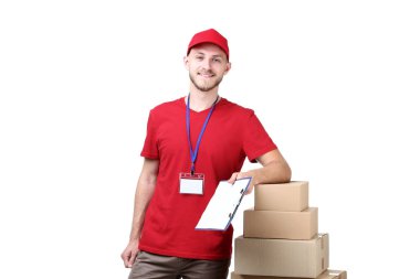 Delivery man with cardboard boxes and clipboard on white background clipart