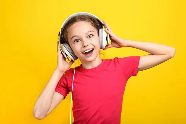黄色背景耳机的年轻女孩 — 图库照片