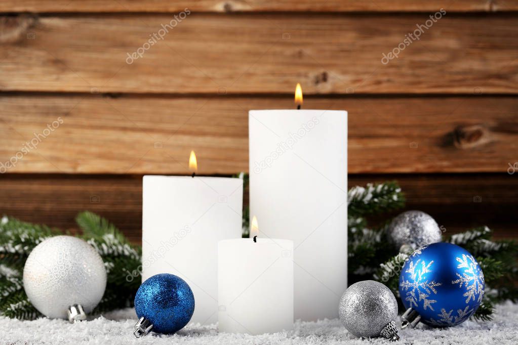 Christmas candles with fir-tree branches and baubles