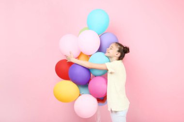 Sevimli Genç kız pembe bir arka plan üzerinde renkli balonlar ile