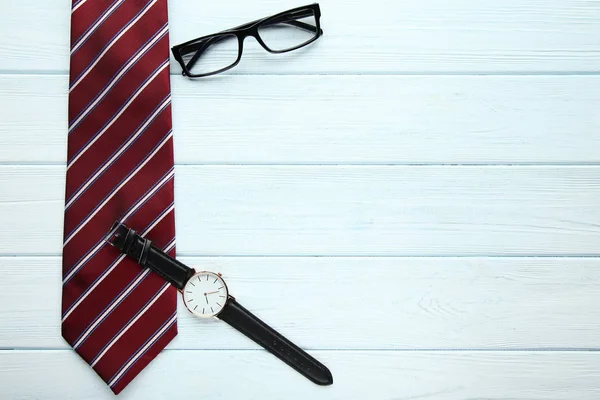 Striped Tie Wrist Watch Glasses Wooden Table — Stock Photo, Image