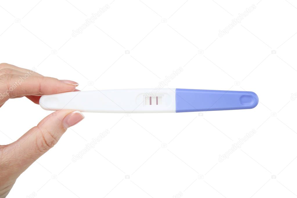 Female hand holding pregnancy test on white background