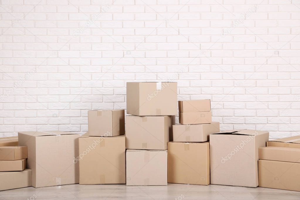 stacked cardboard boxes on brick wall background