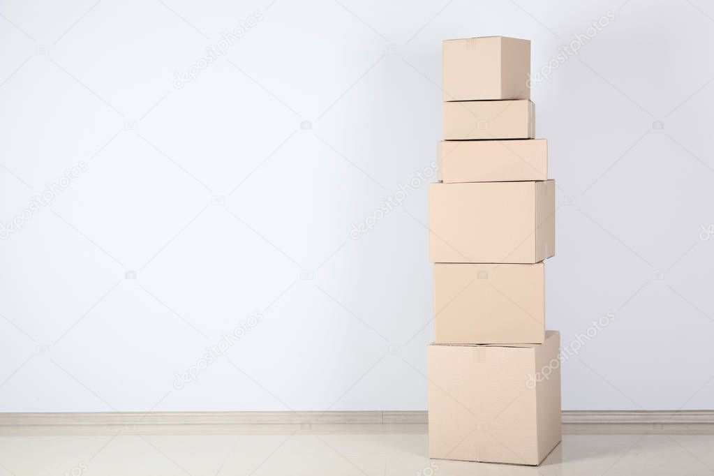 stacked cardboard boxes on grey background