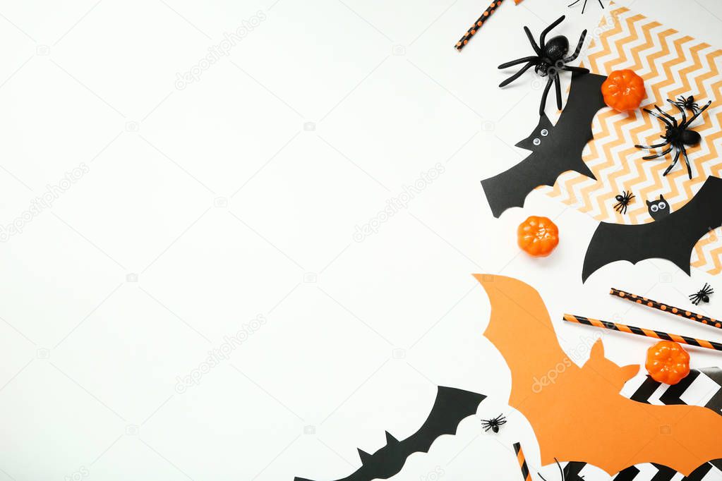 Halloween paper decorations with pumpkins and spiders on white background