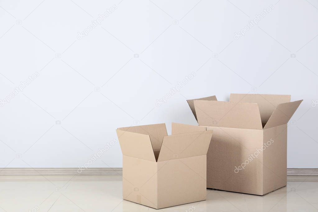 two opened cardboard boxes on grey background