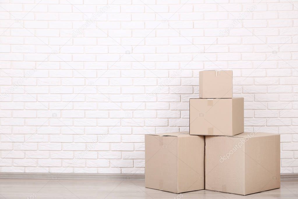 stacked cardboard boxes on brick wall background