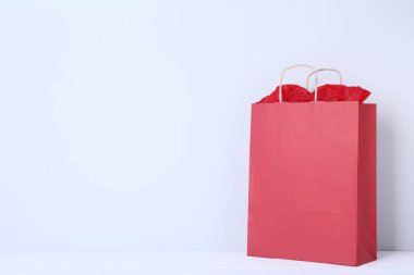 Kağıt gri arka plan üzerinde kırmızı alışveriş çantası