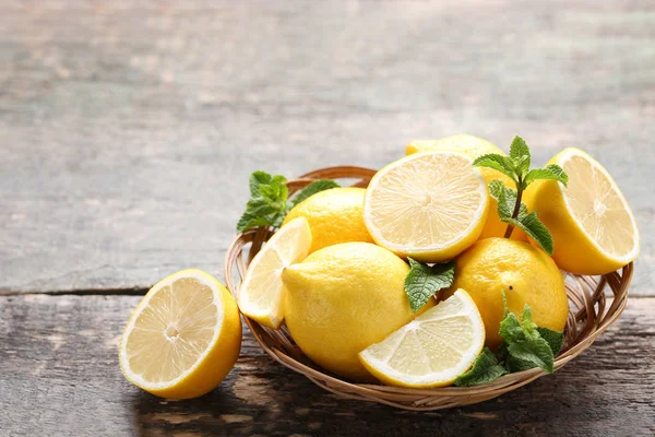 Ripe Whole Halved Lemons Basket Wooden Table — Stock Photo, Image