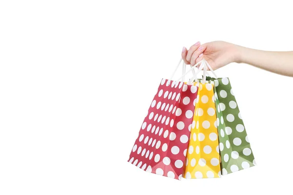 Weibliche Hand Mit Bunten Gepunkteten Einkaufstaschen Auf Weißem Hintergrund — Stockfoto