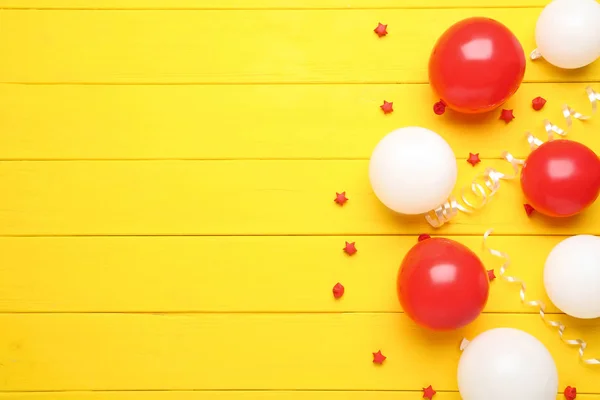 Red White Balloons Paper Stars Yellow Wooden Background — Stock Photo, Image