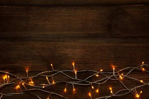 Christmas Garland Lights Brown Wooden Table — Stock Photo, Image