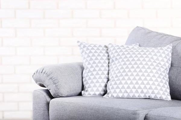 Modern Grey Sofa Pillows Brick Wall Background — Stock Photo, Image