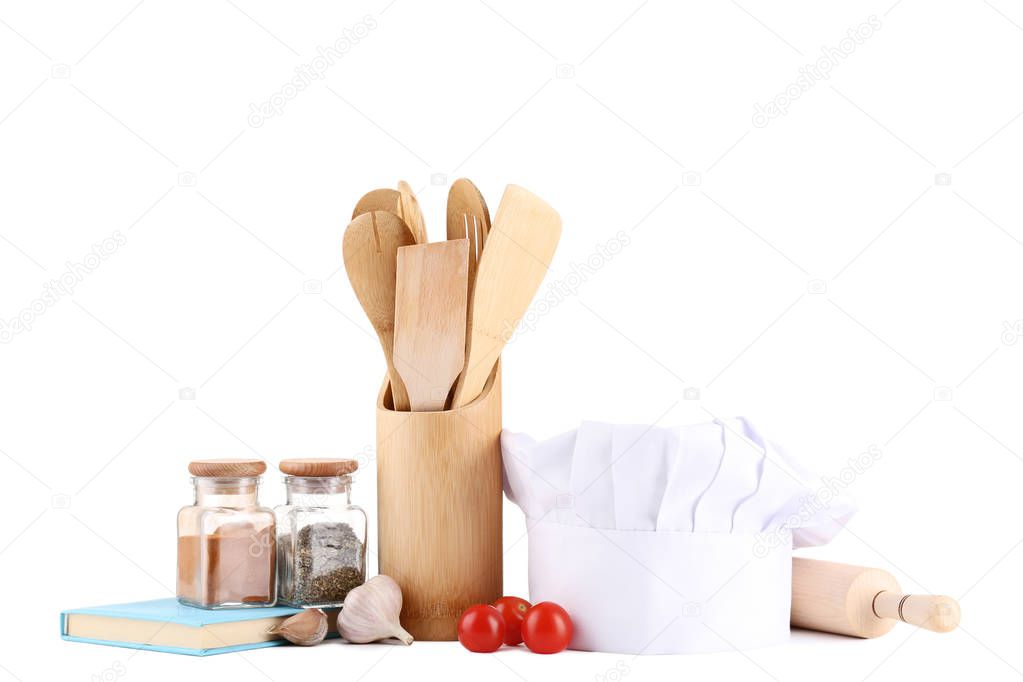 Chef hat with cooking utensils and vegetables on white background