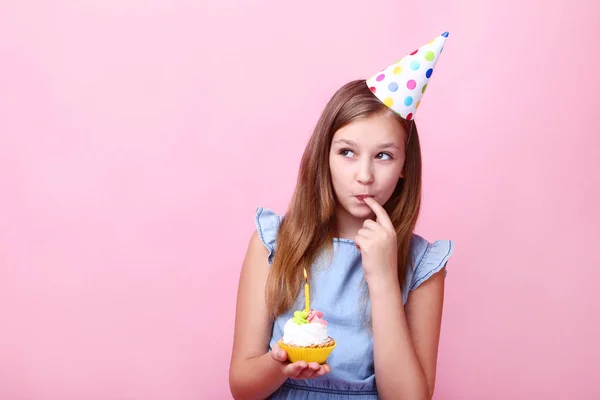 Słodkie Dziewczyny Urodziny Hat Gospodarstwa Ciastko Różowym Tle — Zdjęcie stockowe