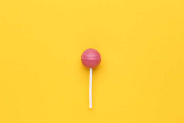 Sweet lollipop on yellow background
