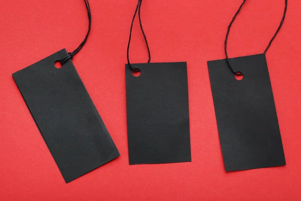 Black sale tags on red background