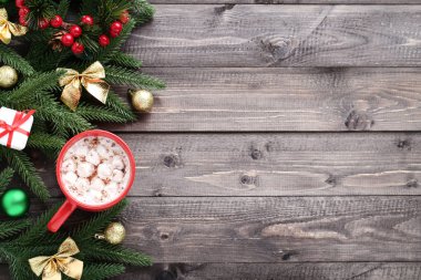 Kapuçino ahşap masa üzerinde Kupası ve köknar ağacı dallarında marshmallow ile