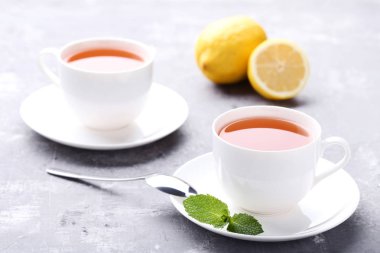 Bardak çay ile nane yaprakları ve limon ahşap tablo