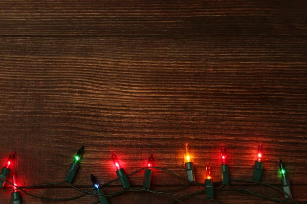 Christmas Garland Lights Brown Wooden Table — Stock Photo, Image