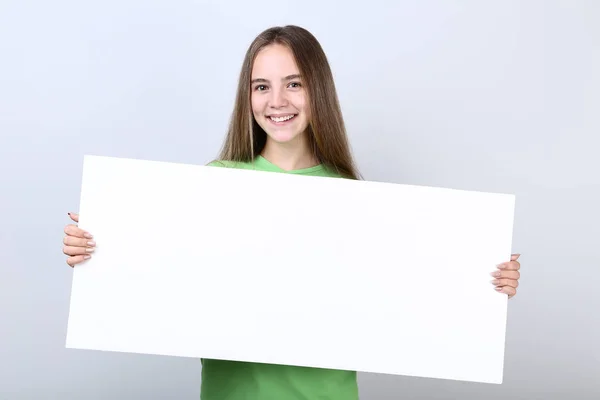 Jovencita Sosteniendo Tablero Blanco Sobre Fondo Gris — Foto de Stock