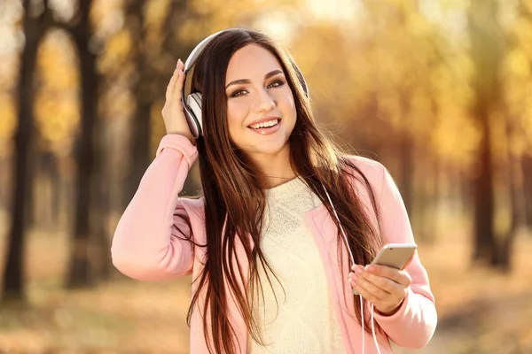 Mooie Vrouw Met Hoofdtelefoon Smartphone Herfst Park — Stockfoto