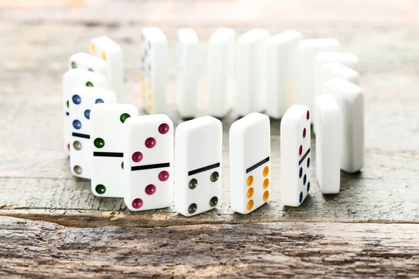 Dominoes in circle on grey wooden table