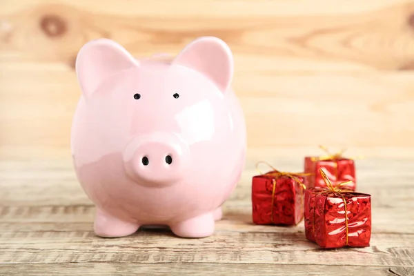 Rosa Sparschwein Mit Roten Geschenkboxen Auf Holztisch — Stockfoto