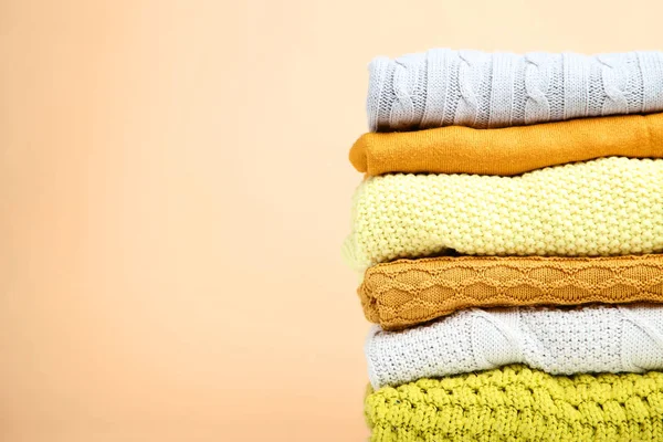 Stack Folded Sweaters Beige Background — Stock Photo, Image