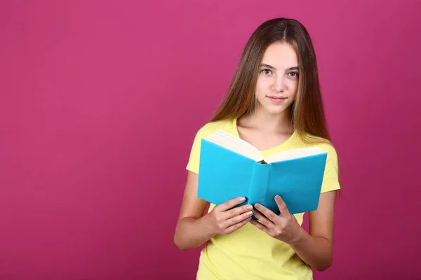 Chica Joven Con Libro Sobre Fondo Rosa — Foto de Stock
