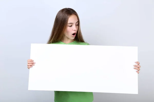 Surprised Young Girl Holding Blank Board Grey Background — Stock Photo, Image