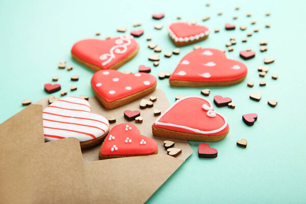 Homemade valentine cookies with envelope on mint background