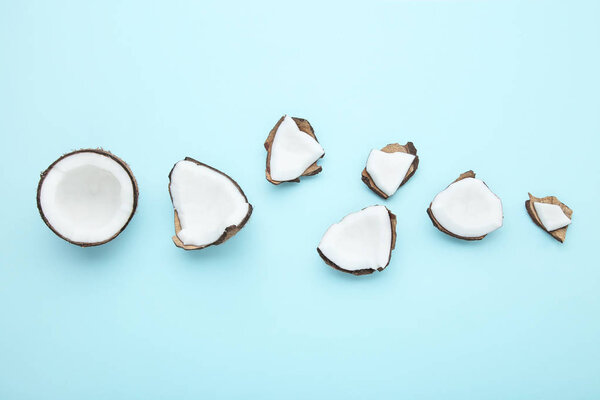 Pieces of coconuts on blue background
