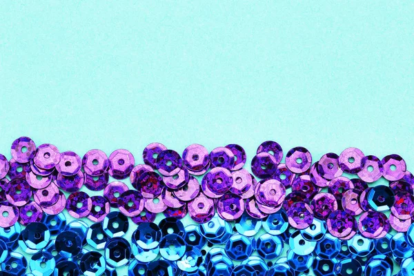 Round purple and blue sequins on mint background