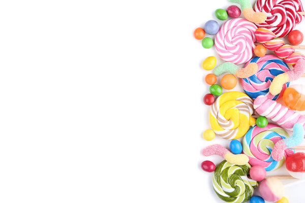 Sweet candies and lollipops on white background