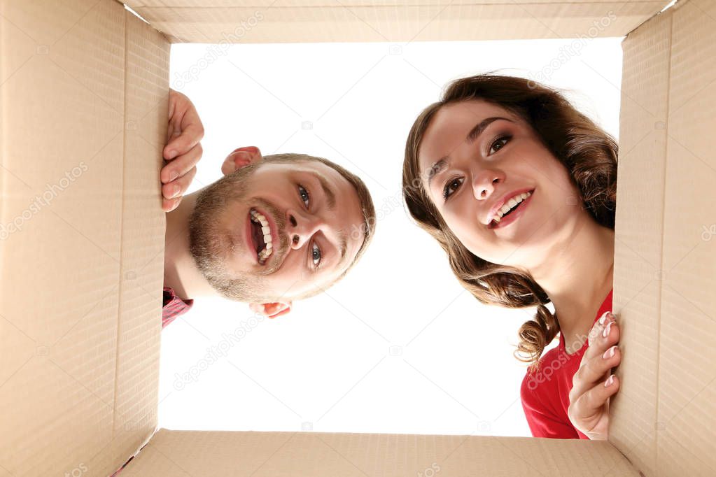 Young man and woman looking inside the box