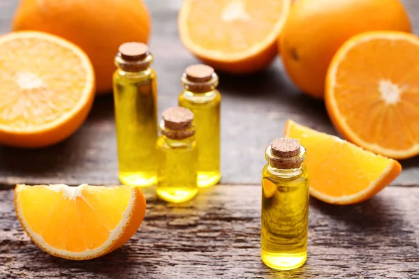 Aceite Naranja Botellas Sobre Mesa Madera Gris —  Fotos de Stock