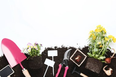 Garden tools with flowers on the ground clipart