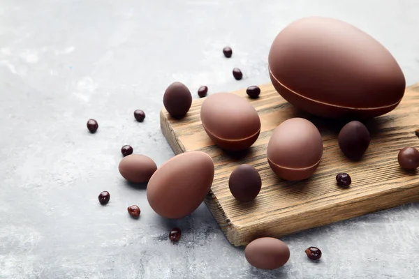 Çikolata Paskalya Yumurtaları Ile Kesme Tahtası Üzerinde Gri Ahşap Masa — Stok fotoğraf
