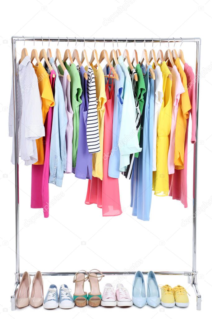 Clothes hanging on wooden hanger and different shoes