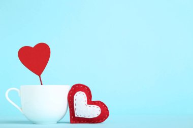 Kumaş ve ahşap kalpleri ile mavi zemin üzerine beyaz Kupası