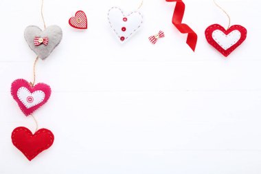 Clothespin ve şerit Beyaz ahşap masa üzerinde renkli kumaş kalpler