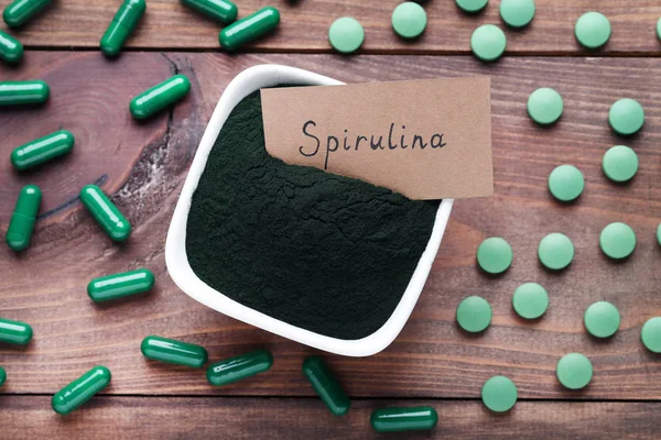 Spirulina powder and tablets with inscription on paper card