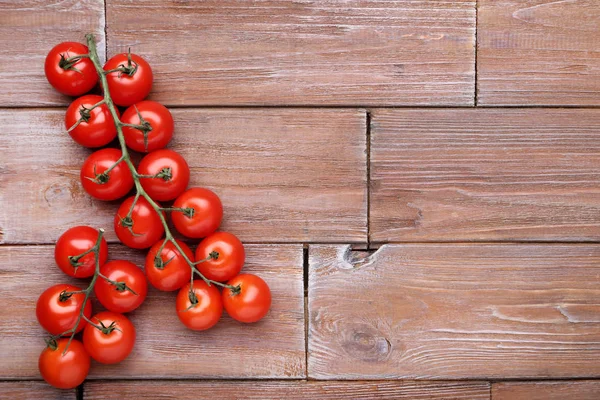 Cherry tomatoes on brown wooden table