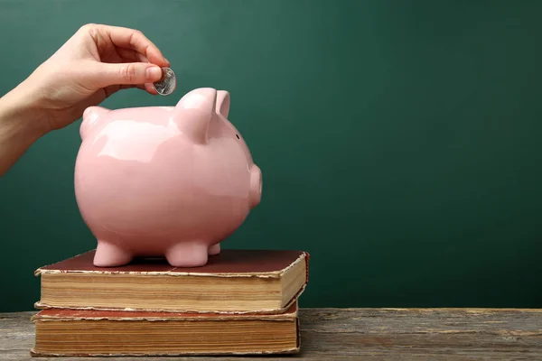 Female Hand Putting Coin Pink Piggy Bank Wooden Table — Stock Photo, Image